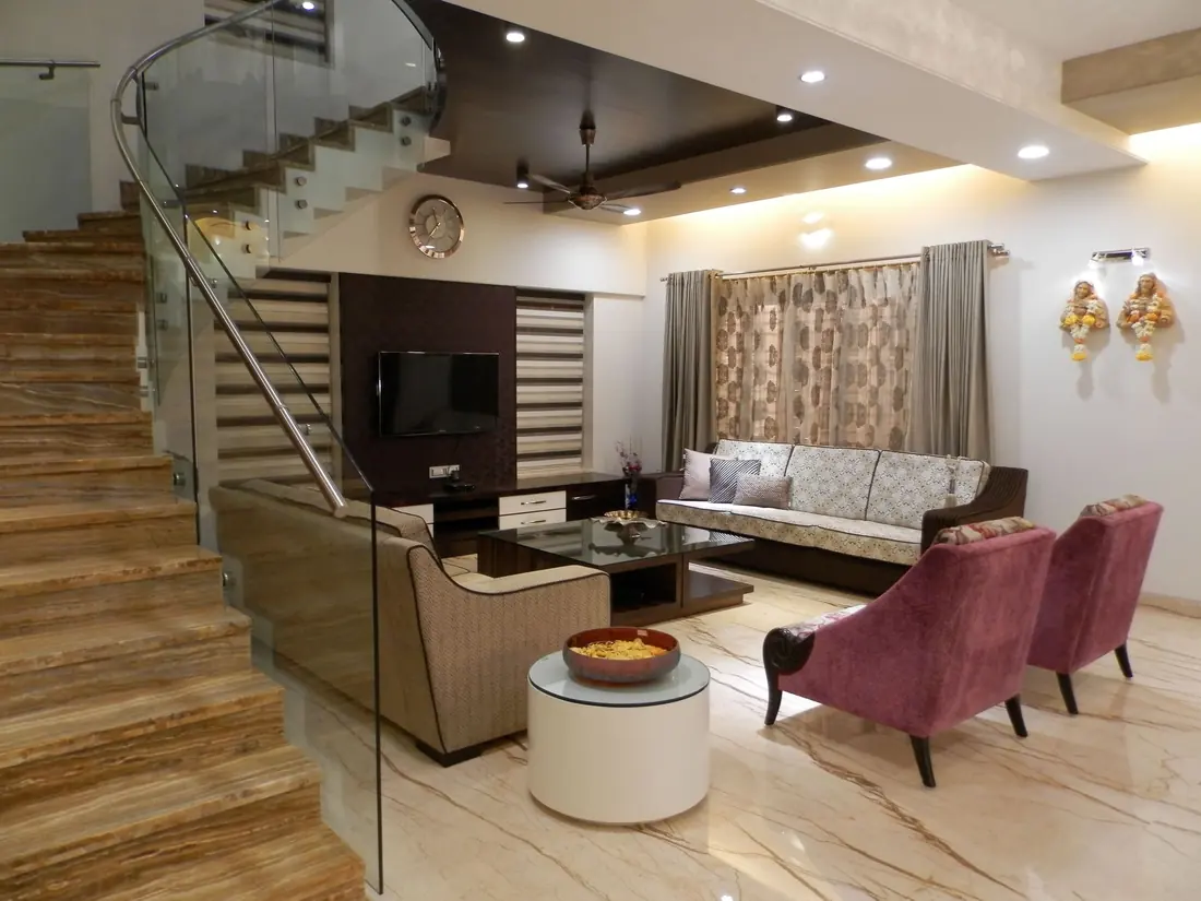 Living room with a curved glass staircase, marble floor and plum armchairs